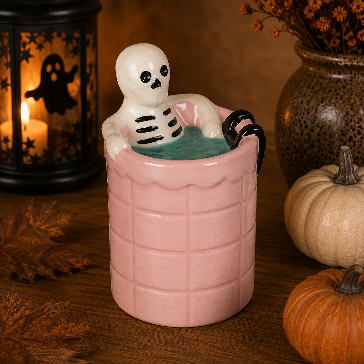 Quemador esqueleto en bañera rosa Halloween vista frontal con vela encendida